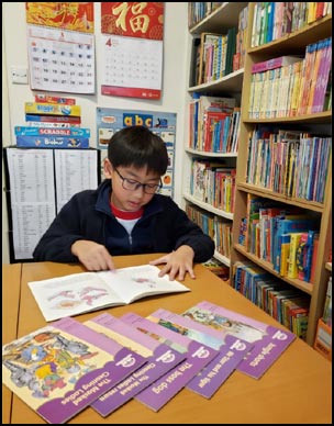 A primary student enjoys reading from the Oxford Reading Tree series